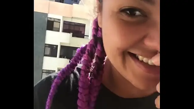 Hot brunette shows her tits to her neighbors while masturbate in her balcony